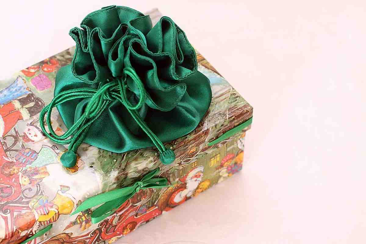 A colorful gift box surrounded by cheerful flowers and ribbons.