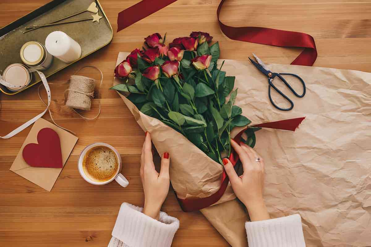 Woman expertly arranges a bouquet of red roses with precision